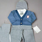 Baby outfit with blue sweater, gray pants, and matching hat on a brown background