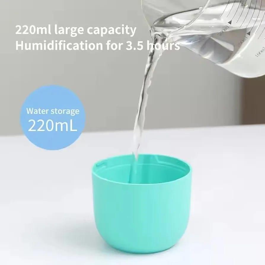 Smart Aroma Diffuser misting on desk next to laptop – bedroom setting