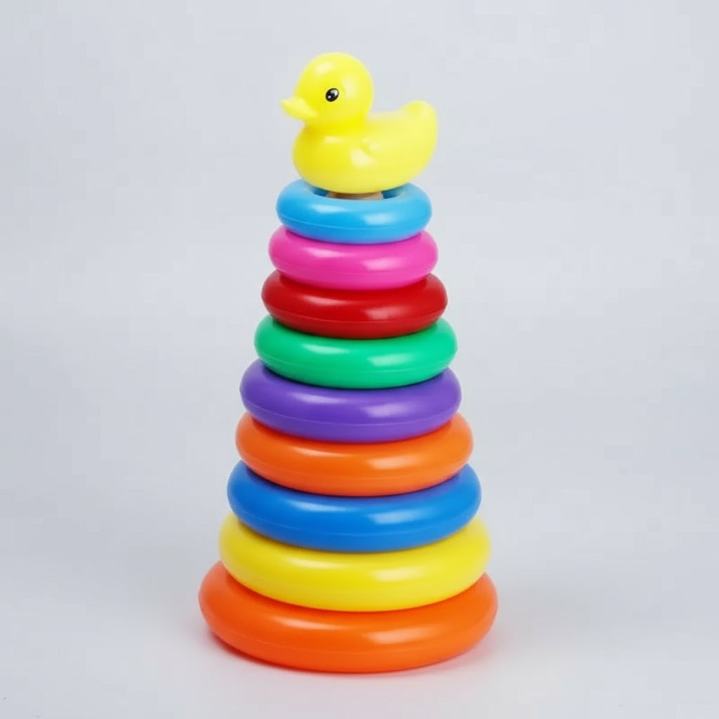 Colorful stacking rings toy with a yellow rubber duck on top against a white background